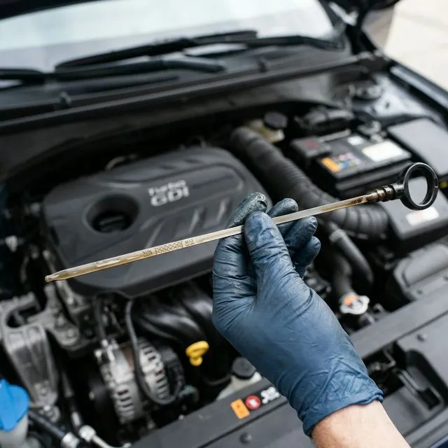 Hazy engine oil on dipstick showing fuel dilution